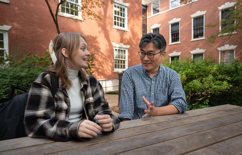 two people conversing while at a table