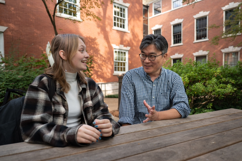 two people conversing while at a table
